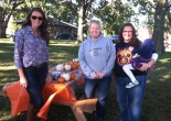 picture: League members Margarita Fuksman, Katie Piere and Susan Mize prepare for the fall Treat Our Troops event at Schaake's pumpkin patch.